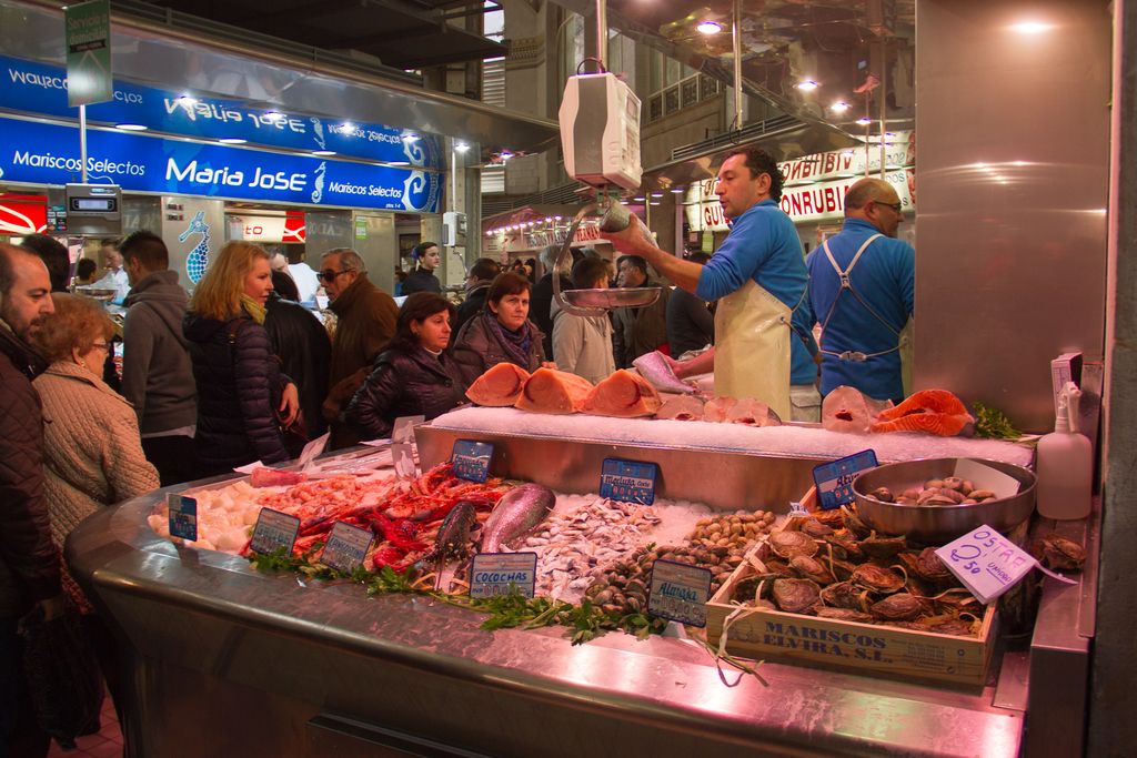 This picture might be taken in a market, in this picture at the bottom there are some fishes and...