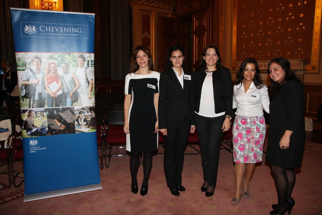 In the foreground of this image, on the left, there is a banner. Chairs in the background. On the...