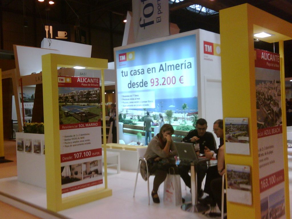 there was a room in which people are sitting in the chairs,in front of a table looking into the...