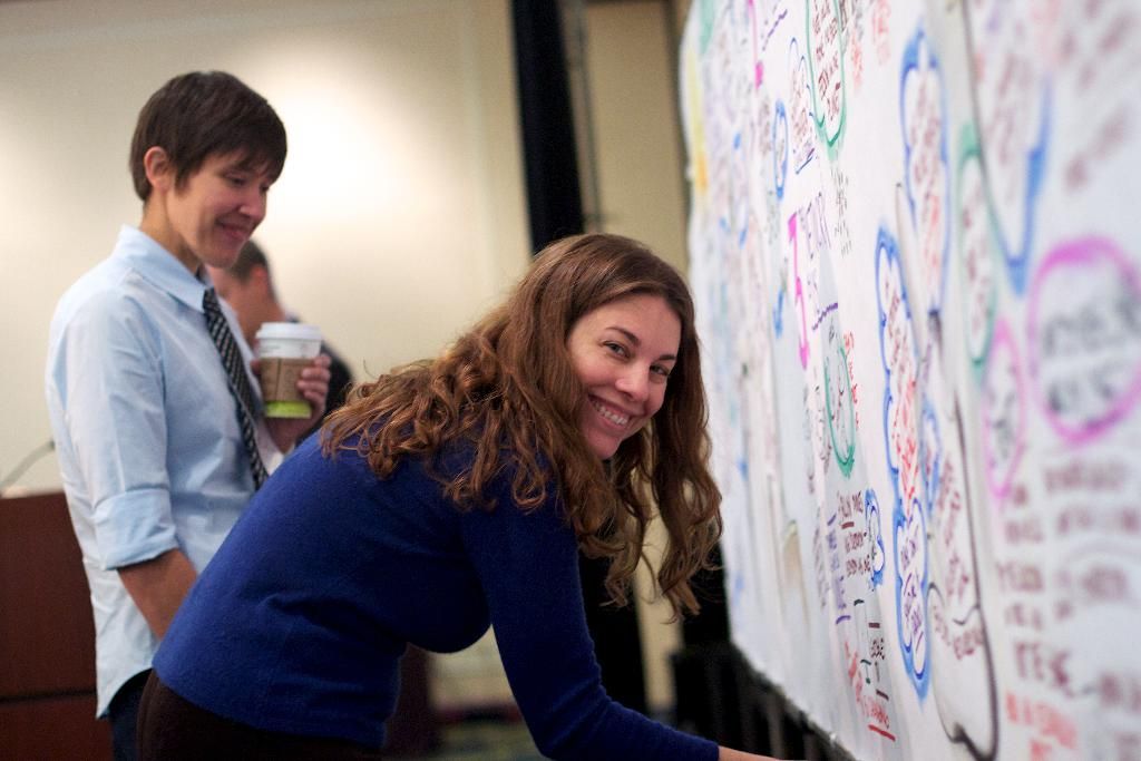 In this image we can see one white board with text attached to the wall on the right side of the...