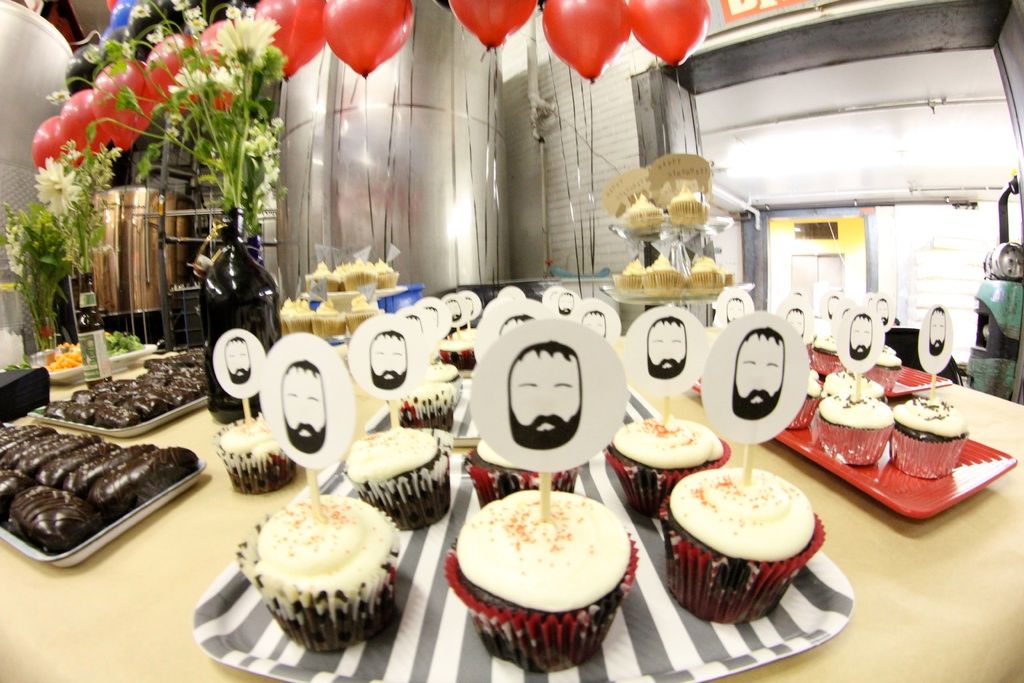 In this image there is a table, on which we can see there are so many cup cakes in the tray and...