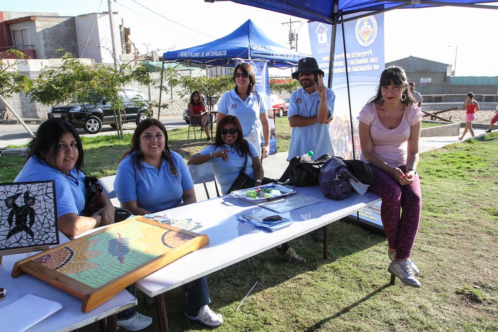 It is an open area there are group of people sitting around a table,on the table there are some...