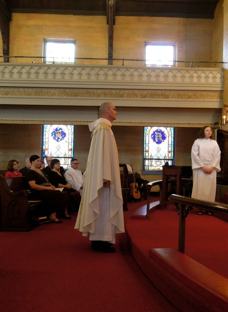 At the bottom, we see a carpet in red color. On the right side, we see a railing. Behind that, we...