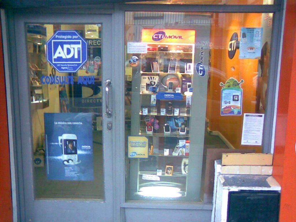 This is a picture of a mobile stall where there are labels stick to the glass , mobiles arranged in...