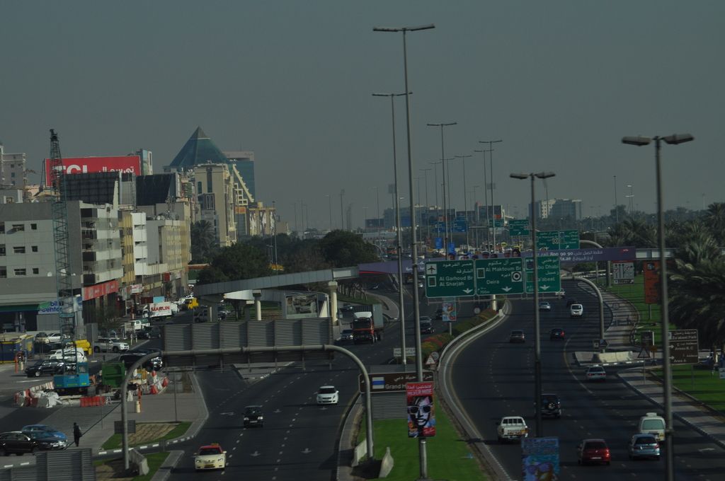 This is the aerial view of a city. in this we can see buildings, towers, motor vehicles,...
