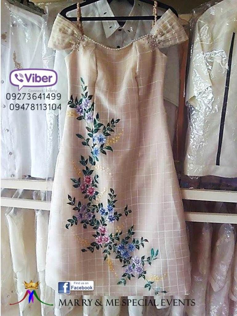 In this picture we can see a pamphlet with peach colored dress and other shirts in the background.