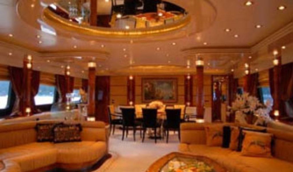 This is a picture of a hotel. In the foreground of the picture there are couches, pillows, chairs,...