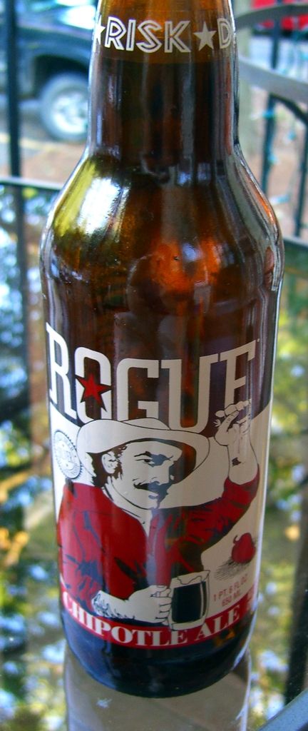 In this picture there is a bottle of cool drink and RISK word is written at the top of the bottle...