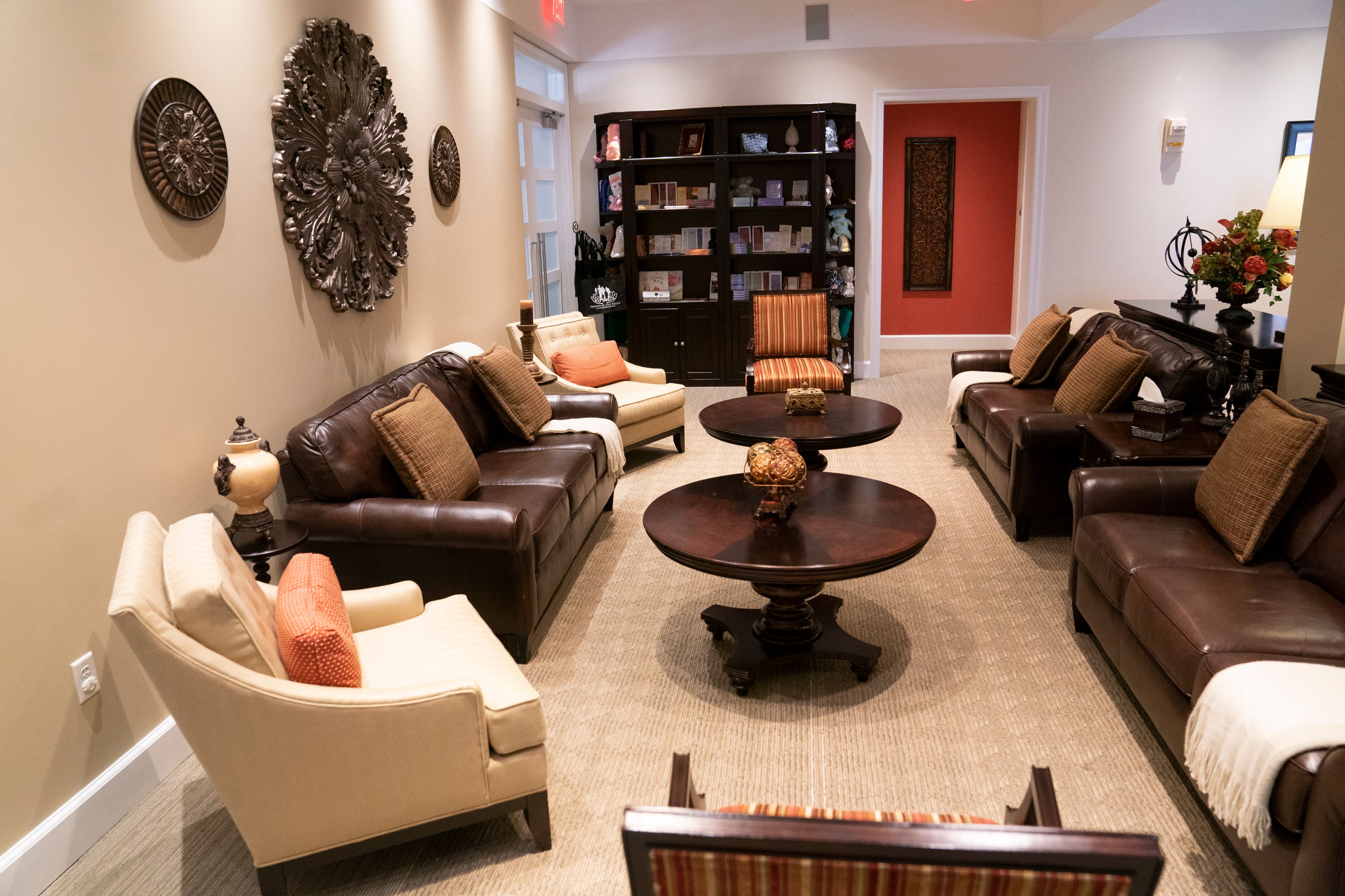 The image shows a living room filled with furniture such as sofas with cushions, chairs, tables,...