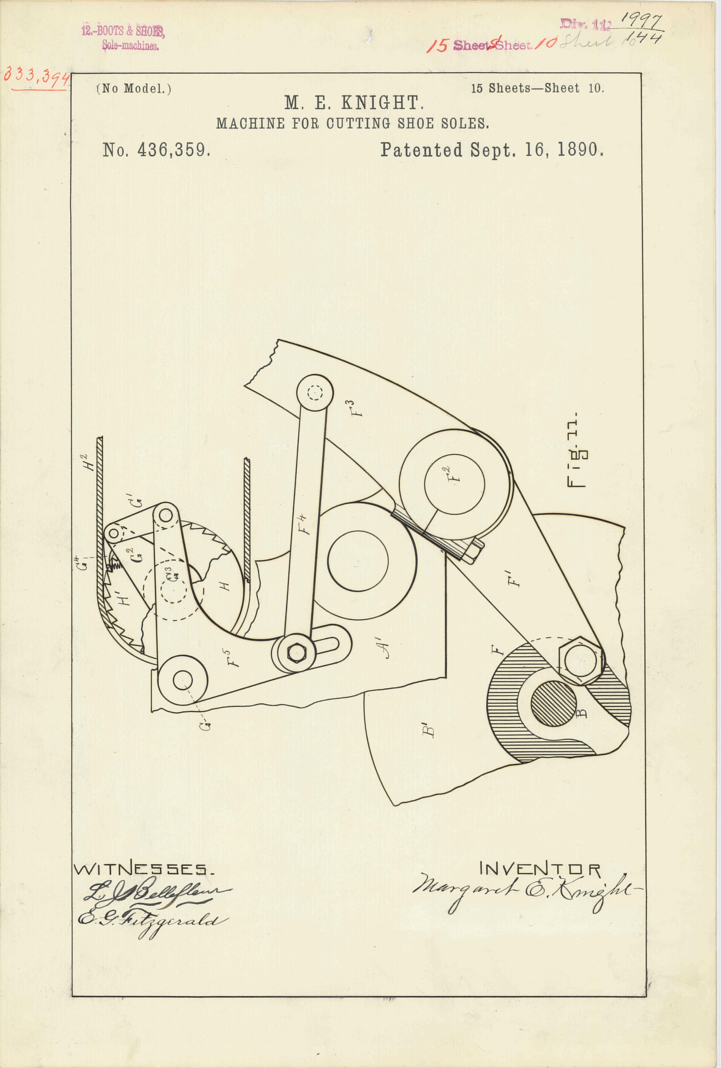 The image shows a drawing of a machine on a piece of paper with text written on it. The paper...