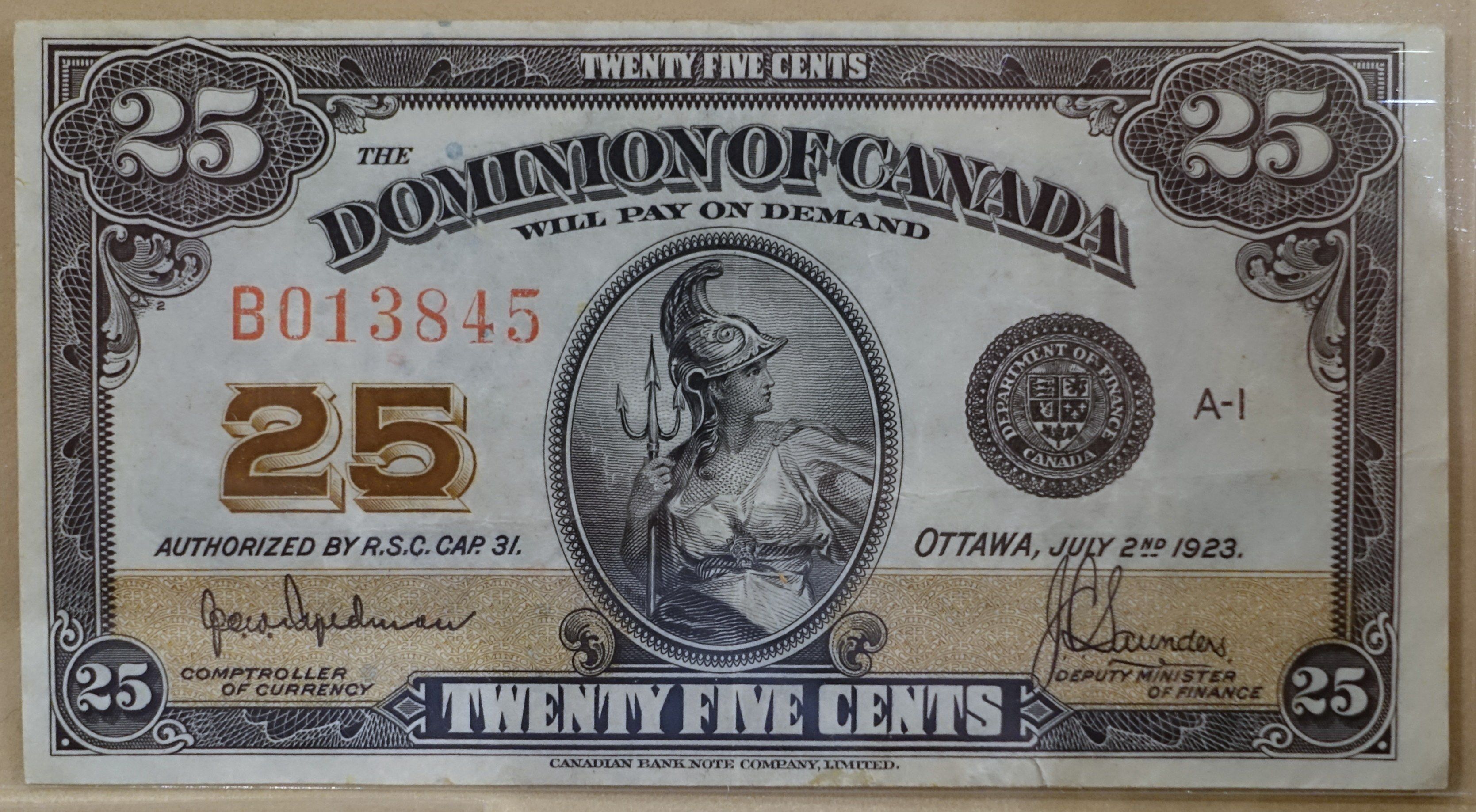 The image shows a Dominion of Canada twenty five cents banknote with a picture of a person on the...