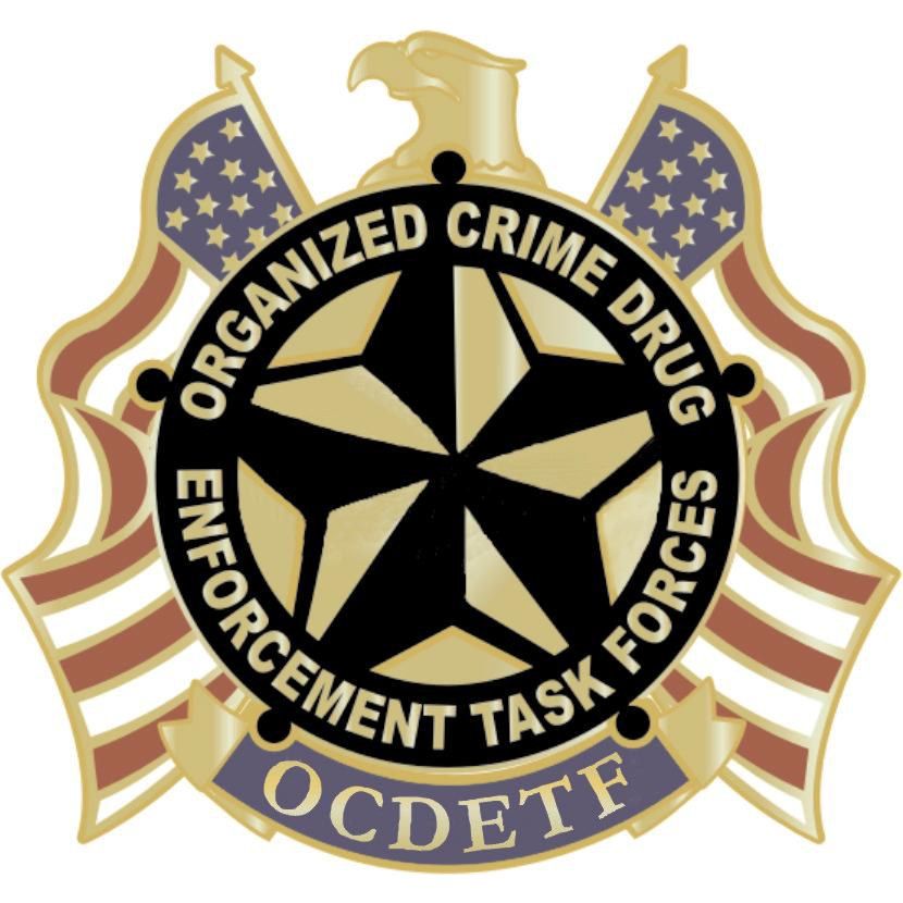 The image shows a logo with the text "Organized Crime Drug Enforcement Task Force" written on it,...