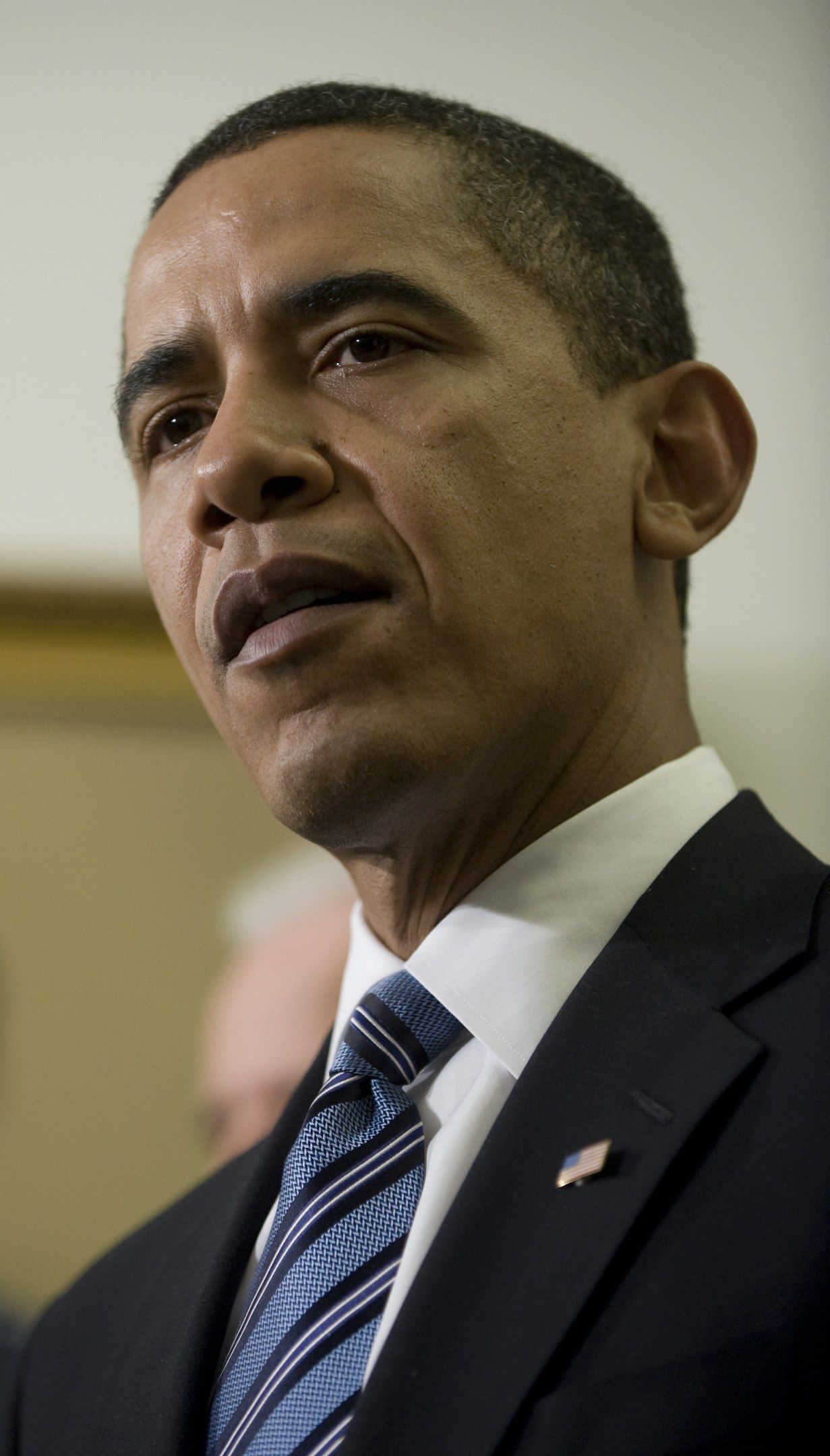 The image shows President Barack Obama speaking during a news conference in the East Room of the...