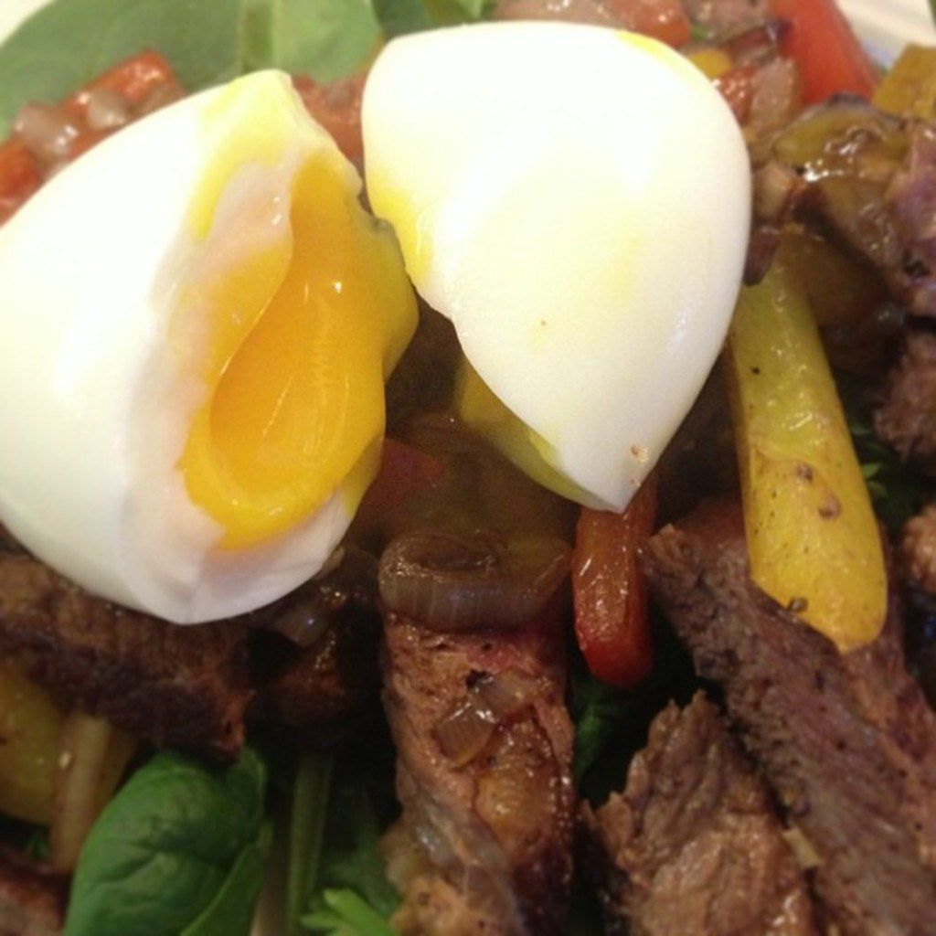 Here in this picture we can see a boiled egg and other meat item present in a bowl.