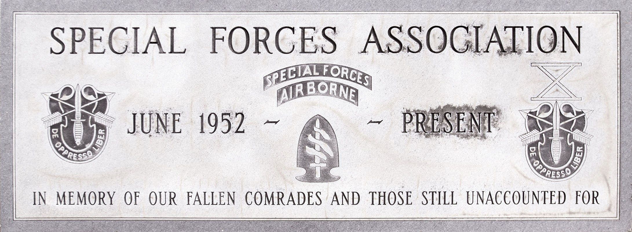 The image shows a plaque with the words "Special Forces Association" written on it, along with...