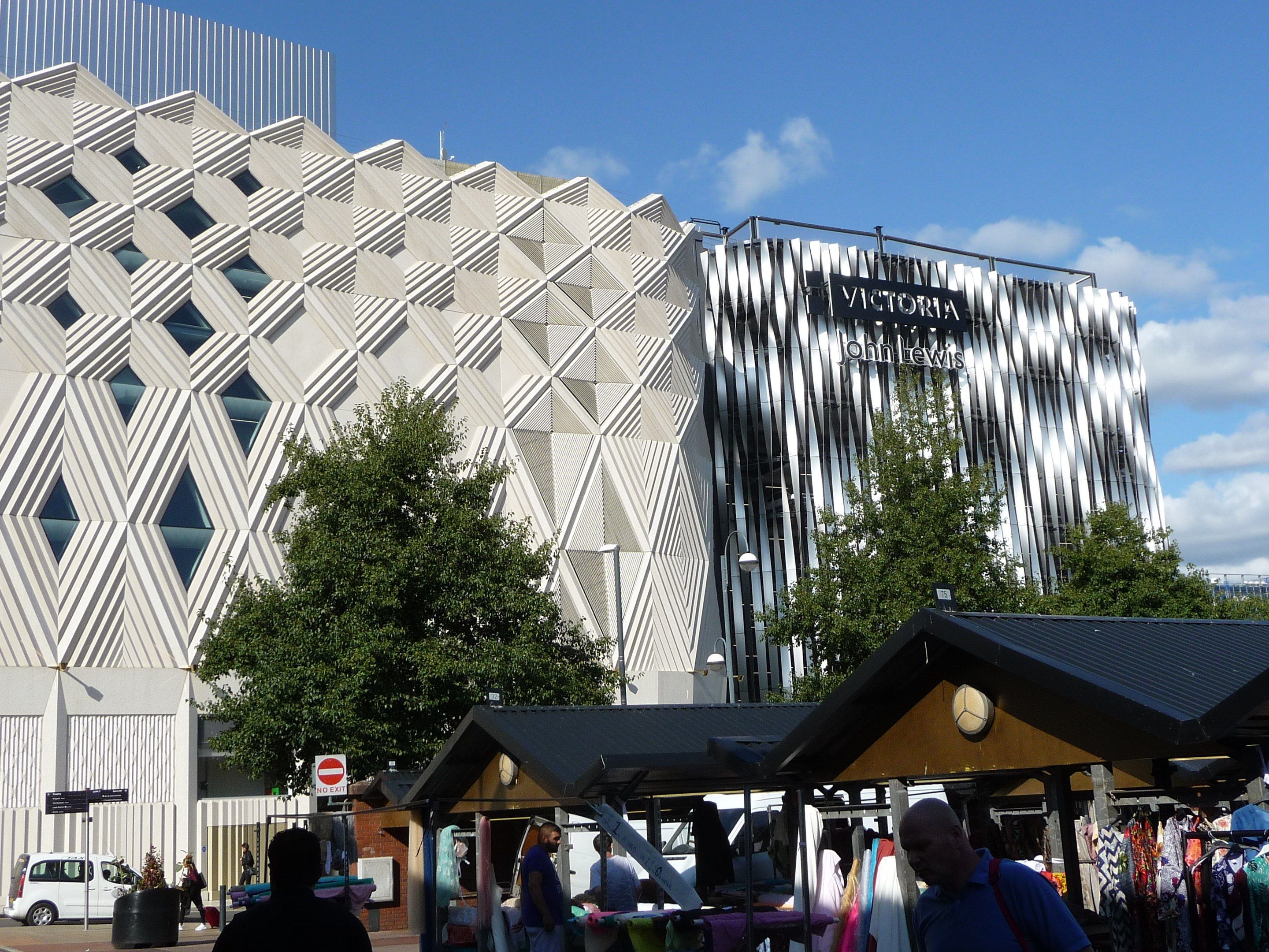 The image shows the Victoria and Albert Museum in Birmingham, England. There are many people...