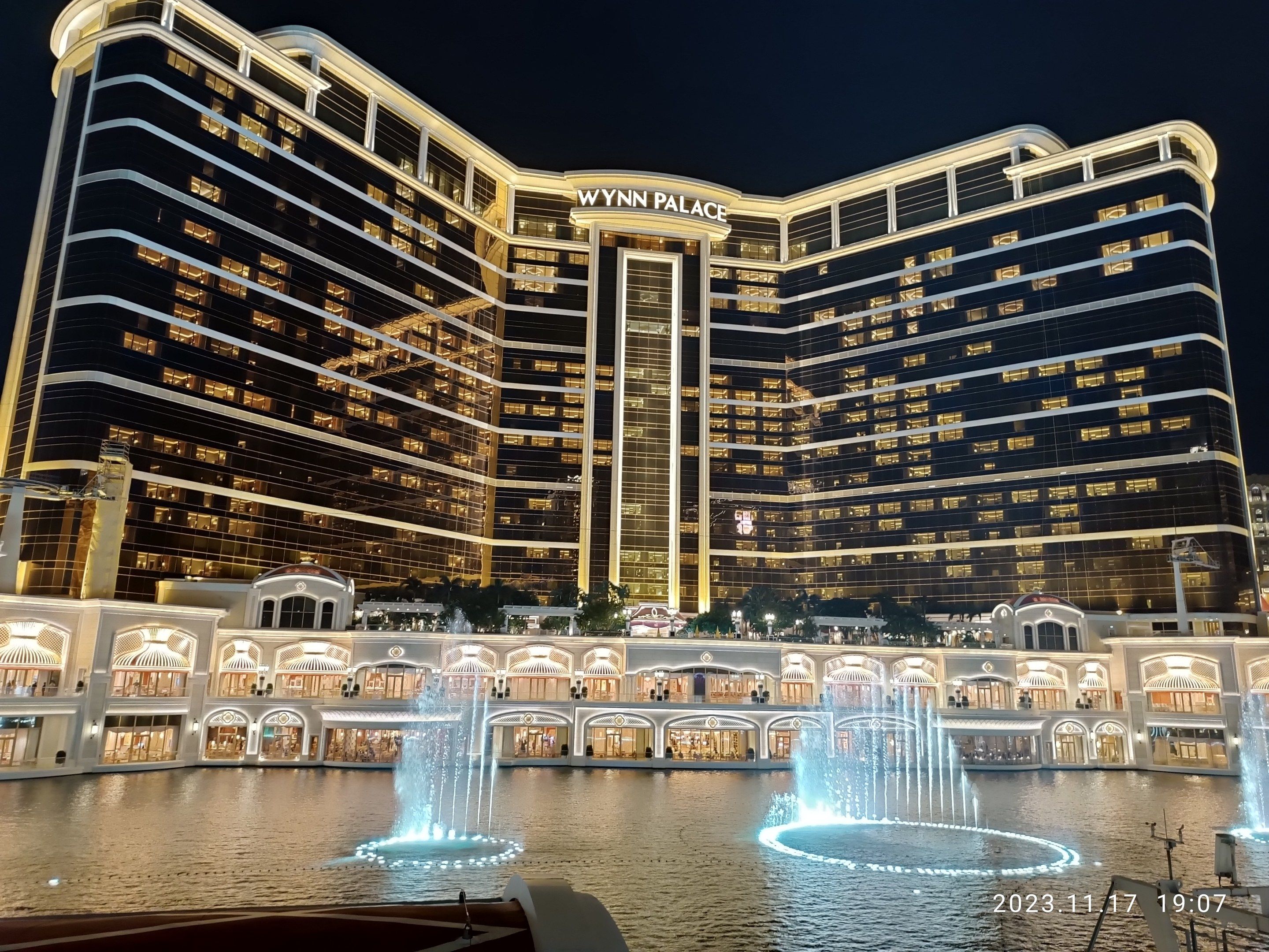 The image shows Wynn Palace Hotel and Casino in Las Vegas, Nevada. It is a large building with...