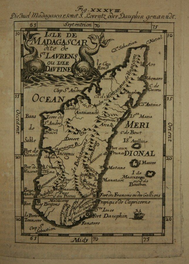 The image shows an old book with a map of Madagascar on it. The map is detailed and shows the...