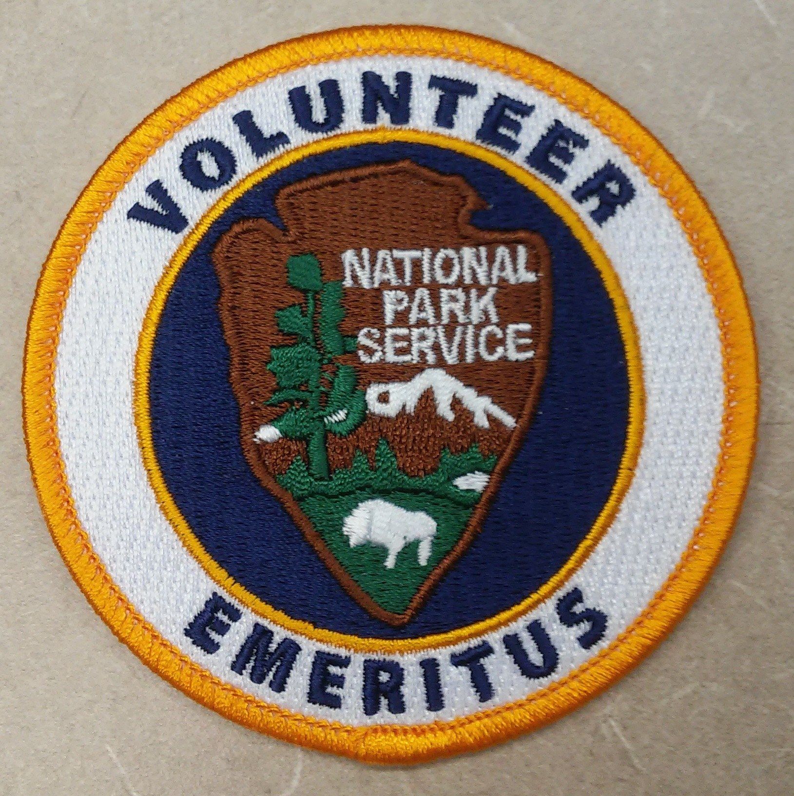 The image shows a patch with the words "Volunteer National Park Service Emeritus" written in bold...