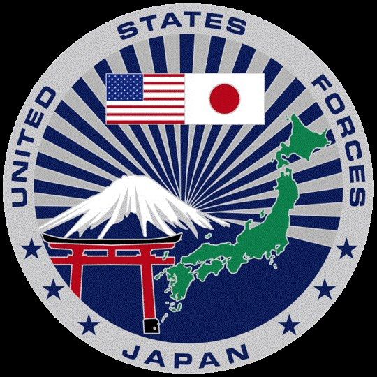 The image shows the United States Forces Japan logo, which consists of a blue circle with a white...
