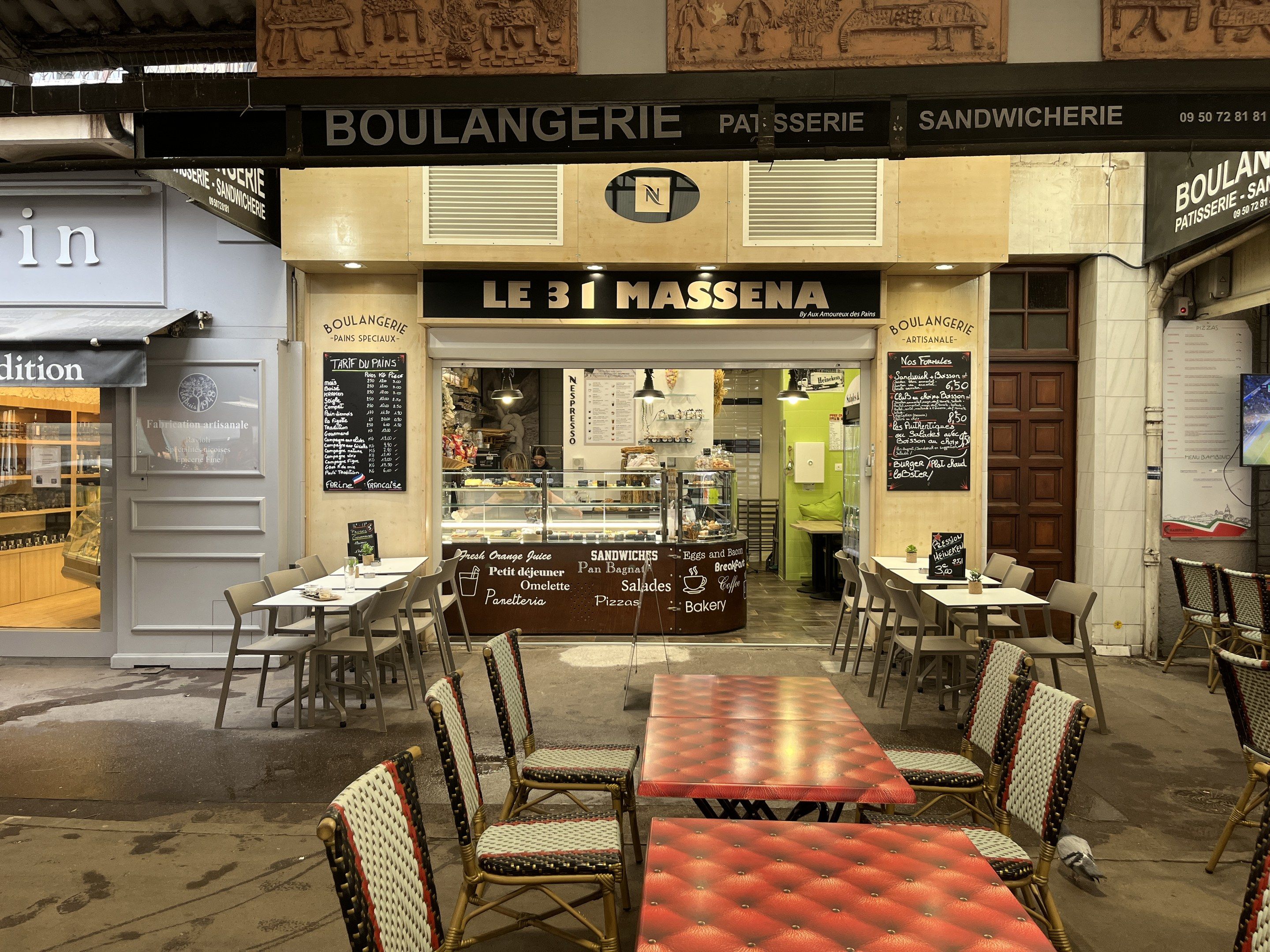 The image shows a restaurant with tables and chairs in front of it, located in Paris, France. The...
