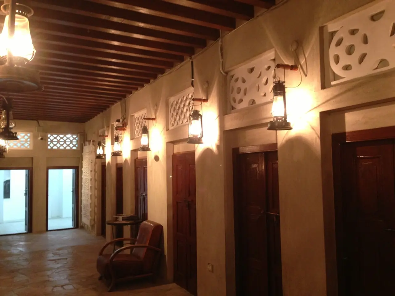 In this image we can see some rooms which were closed, to the each room there is lamp which is...