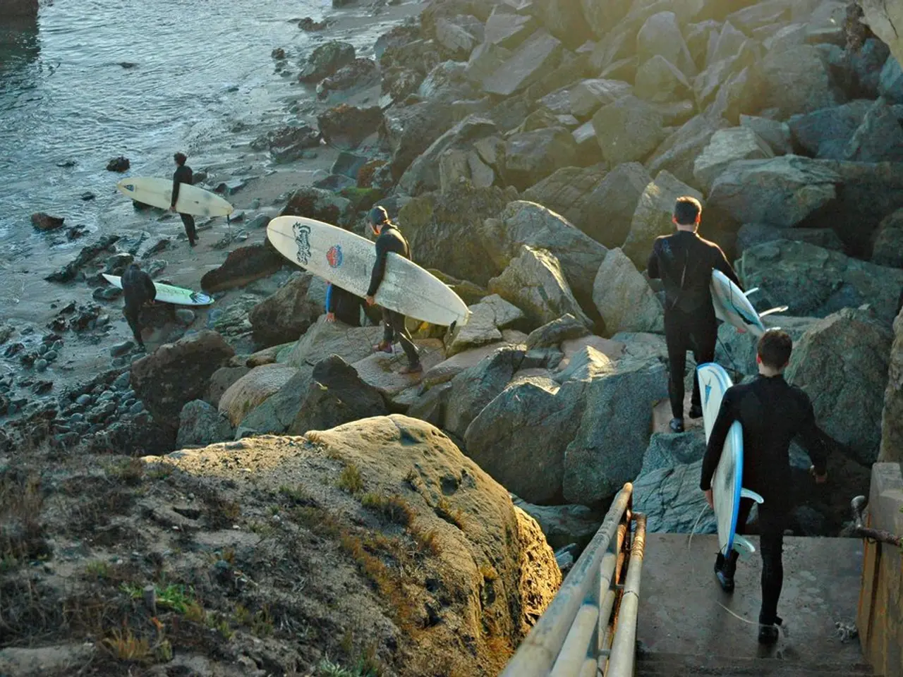 In this picture there are the rocks at the right side of the image and some people they are...