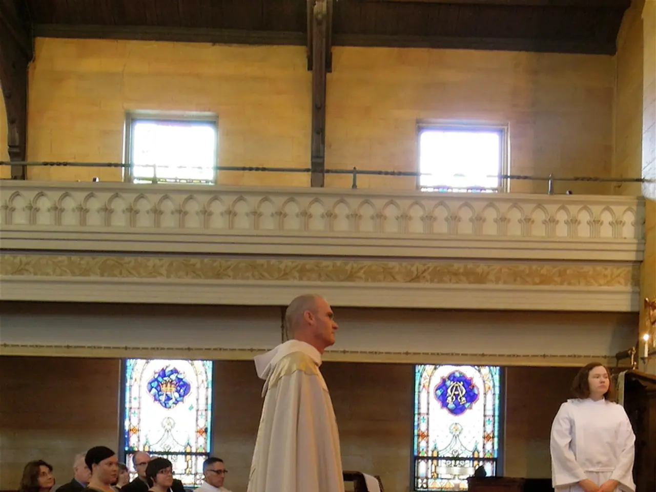 At the bottom, we see a carpet in red color. On the right side, we see a railing. Behind that, we...