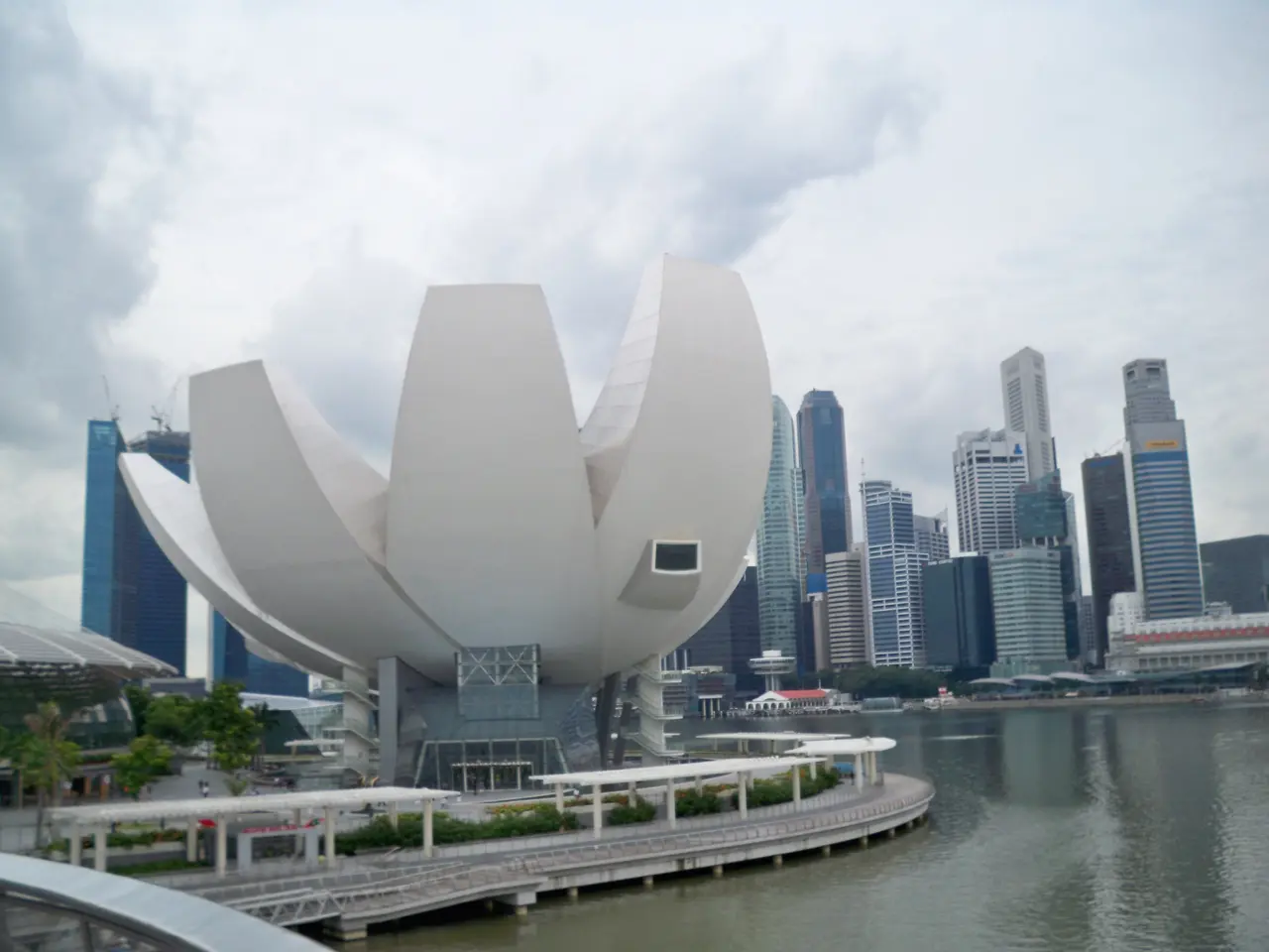 The image shows the Marina Bay Sands Hotel in Singapore, with its iconic lotus flower-shaped...