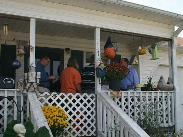 In the center of the image there is a house and there are people inside the house. In front of the...