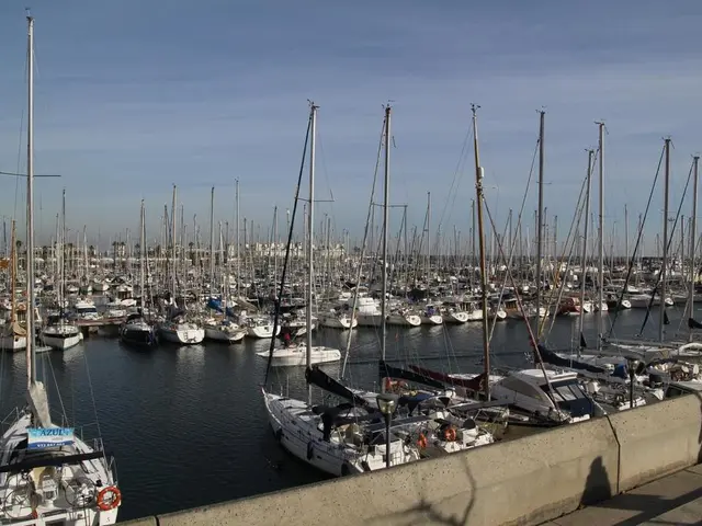 The picture is taken in a shipyard. In the foreground it is dock. In the center of the picture...