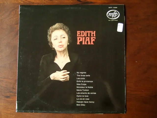 In this picture I can see a photo of a woman, there are words, logo, numbers and a sticker on the...