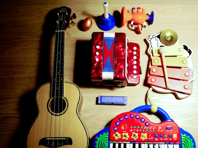 In this picture we have a guitar , a xylophone , harmonicas , a musical piano , a toy , a plastic...