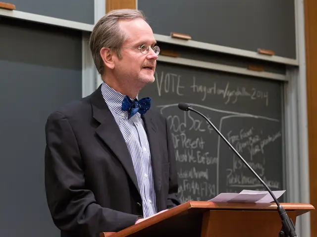 This image consists of a man wearing a black suit is standing in front of the podium and talking in...