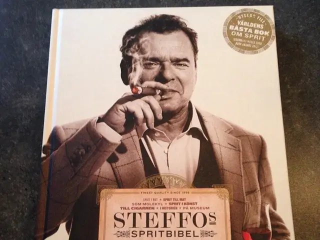 It is an image on the book in black and white, in this a man is smoking he wore coat, shirt.