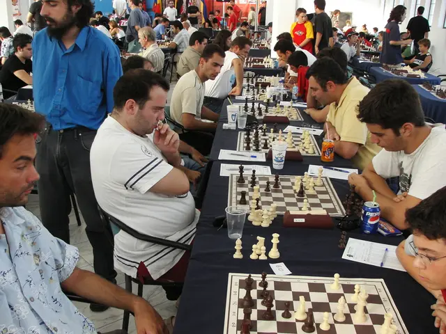 In this image there is a group of persons are playing a chess game. On the left side there is a man...