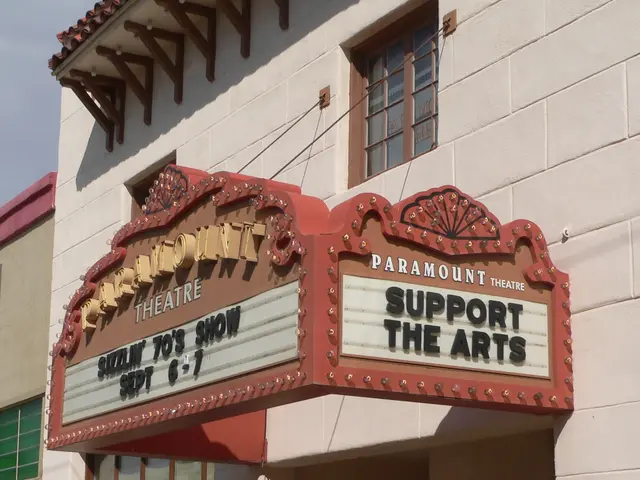 The image shows the Paramount Theatre in Sacramento, California. It is a building with glass...