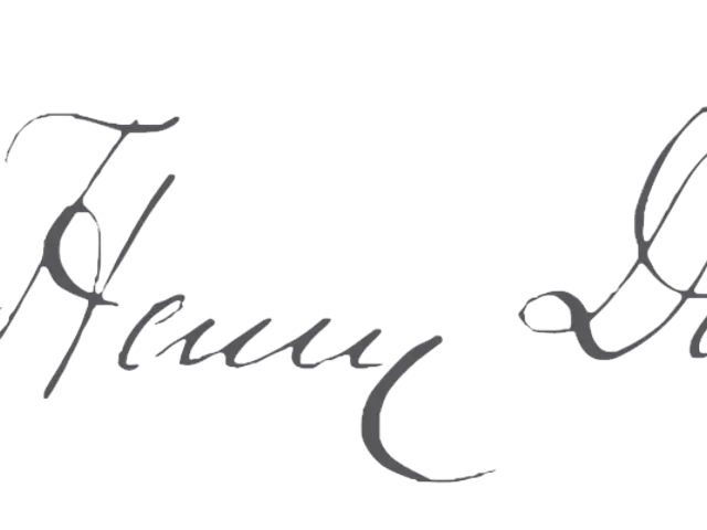 The image shows a white background with the signature of a man in a suit and tie, written in black...
