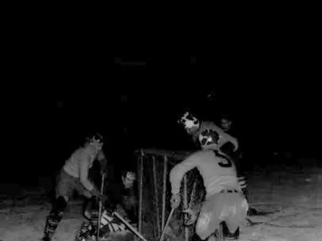 The image shows a group of men playing a game of hockey on the snow, wearing helmets and holding...