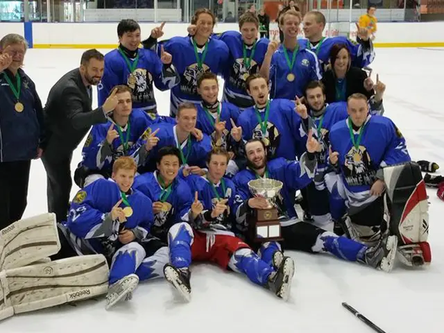 The image shows a group of men standing on top of an ice rink, wearing medals and holding a trophy....