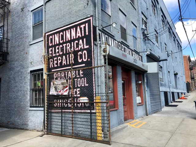 The image shows the Cincinnati Electrical Repair Co. building with windows and doors, a signboard...