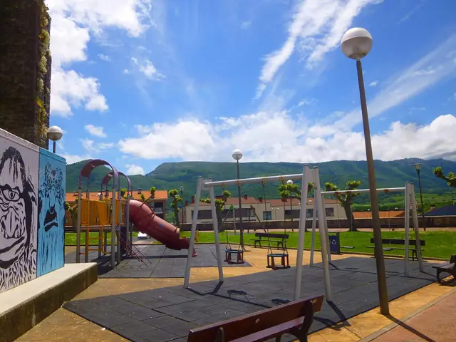 The image shows a playground with swings, a slide, benches, poles, lights, a wall with a painting,...