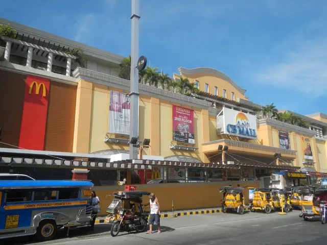 The image shows a bustling street in Cebu City, Philippines, with a variety of vehicles and people...