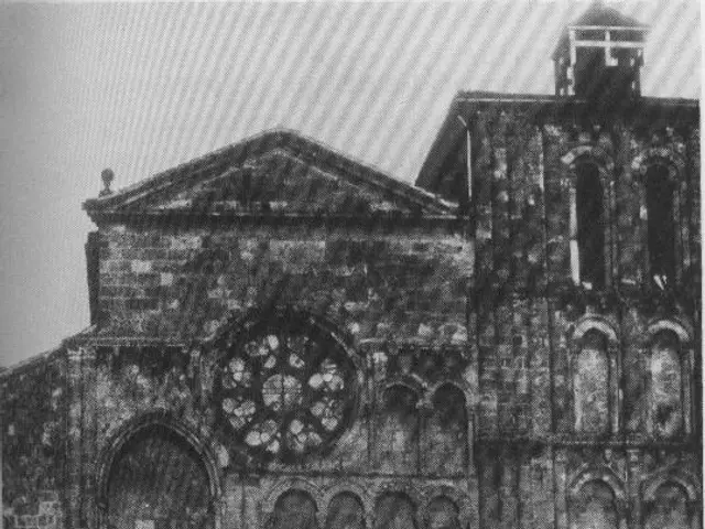 The image shows a black and white photo of an old building with a clock tower, set against a...