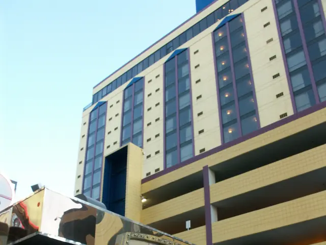 The image shows the Sands Hotel and Casino in Las Vegas, Nevada. It is a large building with glass...