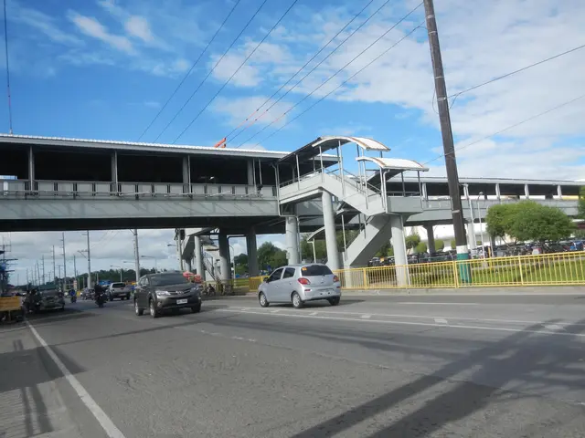 The image shows a tollbooth with vehicles on the road, a bridge with pillars and railings, electric...