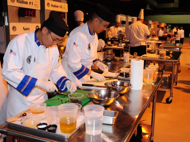 The image shows a group of chefs in a kitchen preparing food. They are wearing white uniforms and...