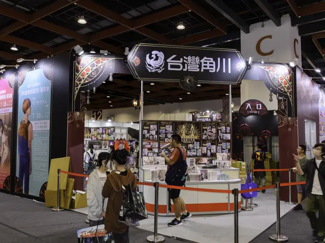 The image shows a group of people standing in front of a booth at a trade show, with some of them...