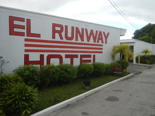 The image shows the El Runway Hotel in Cebu City, Philippines. It features a wall with text on it,...