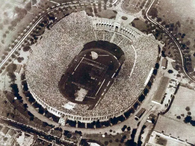 The image shows an aerial view of the Olympic Stadium in Rome, Italy. It is a black and white...